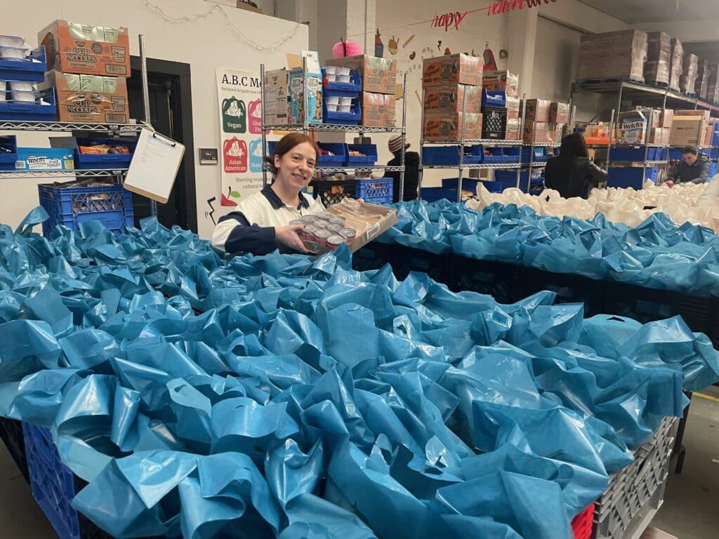 Remitly employee with bags at Backpack Brigade